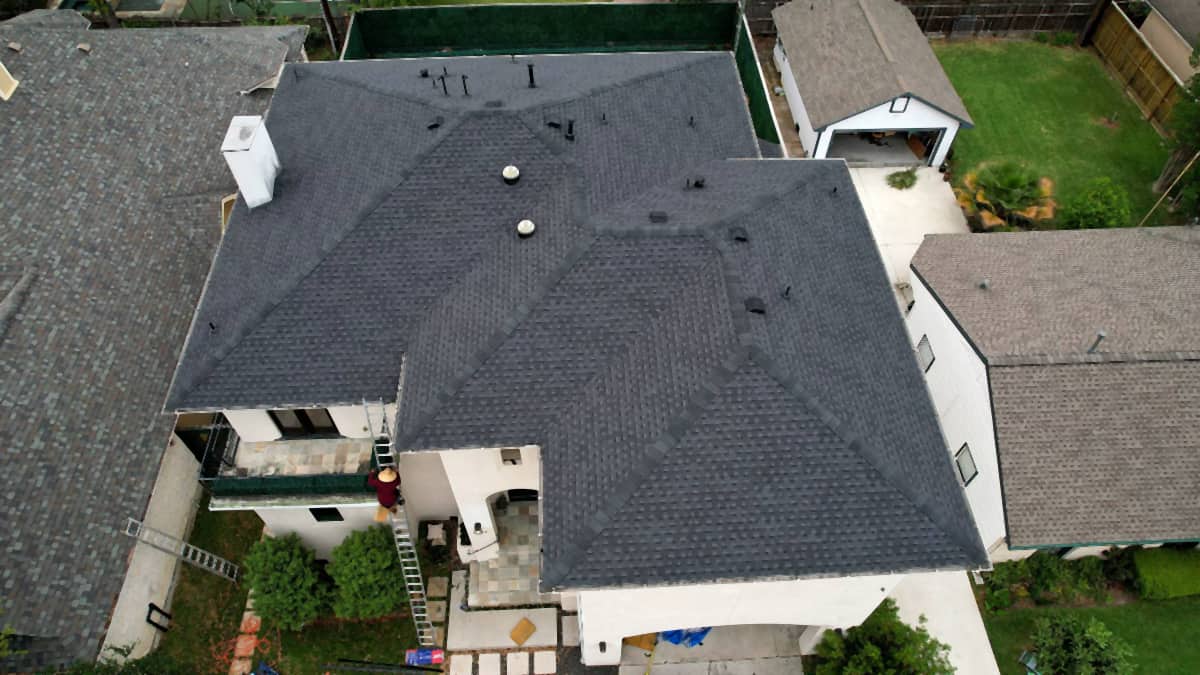 Top-down drone view of a completed shingle roof replacement in Bellaire, TX