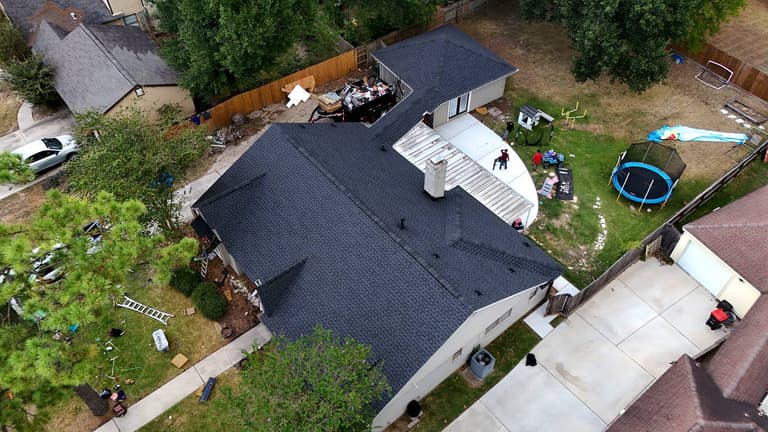 Aerial view of a completed shingle roof replacement on a Cypress, TX home