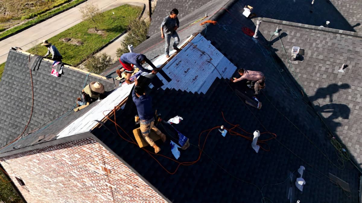 Handy Hands crew installing shingle courses on a South Main, Houston roof replacement