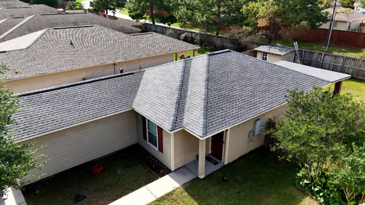 Aerial oblique view of a clean gray hip roof replacement on a Spring, TX home